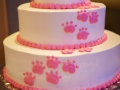 White cake with pink paw prints